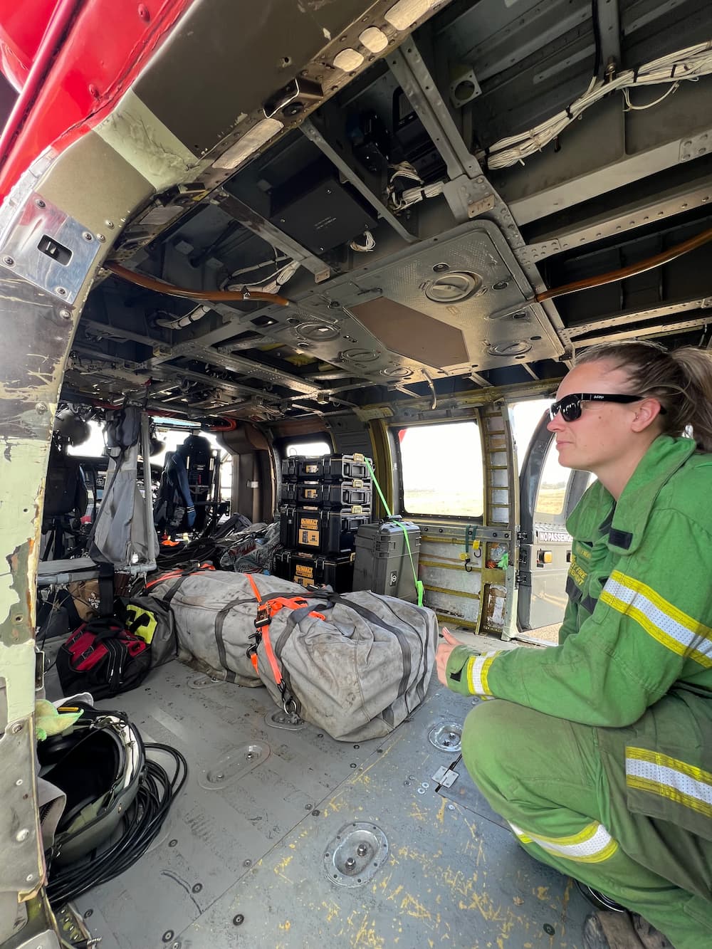 Photo of Courtney Newton kneeling down in an aircraft