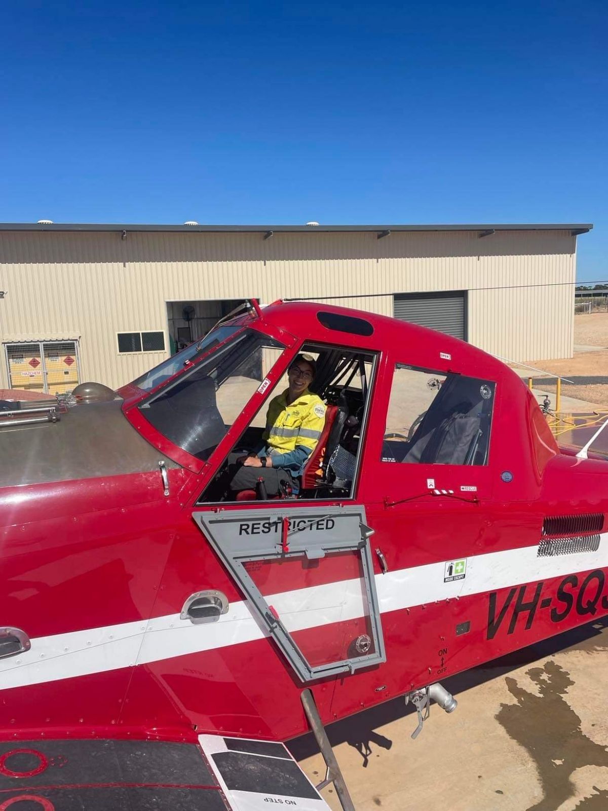 Kiana sitting red plane used in fire suppression